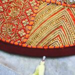 orange now add and create a title with a power word and the title in the short description and with images and videos   current title is multicolor and deep orange Barmer Round Table Runner - Cotton Embroidered Patchwork (flower and leaf design)    now follow all the instructions and guideline of the rankmath    Category is stole and link is and shop now word with link of category https://myvastra.com/product-category/table-runner/     now strictly keep product description in long section length to 3000 words with the reference image     These are instructions and Guideline from the rankmath for seo Basic SEO : 1. Add Focus Keyword to the SEO title. 2. Add Focus Keyword to your SEO Meta Description. 3. Use Focus Keyword in the URL. 4. Use Focus Keyword at the beginning of your content. 5. Use Focus Keyword in the content. 6. Content should be 600-2500 words long.(this content is for product description (long))     Additional SEO : 1. Use Focus Keyword in subheading(s) like H2, H3, H4, etc.. 2. Add an image with your Focus Keyword as alt text. 3. Keyword Density is 0. Aim for around 1% Keyword Density. 4. URL is 25 characters long. Kudos! 5. Link out to external resources. 6. Add DoFollow links pointing to external resources. 7. Add internal links in your content. 8. Set a Focus Keyword for this content. 9. Use Content Al to optimise the Product.         Title Readability : 1. Use the Focus Keyword near the beginning of SEO title. 2. Your title has a positive or a negative sentiment. 3. Your title doesn't contain a power word. Add at least one. 4. Your SEO title doesn't contain a number.     Content Readability : 1. You don't seem to be using a Table of Contents plugin 2. You are using short paragraphs. 3. Your content contains images and/or video     keep the order of content: 1. title of product 2. create a url with the focus keyword 3. product decription (long) 4. Product short description 5. Rankmath meta description 6. focus keyword 7. ALT Tag for product images